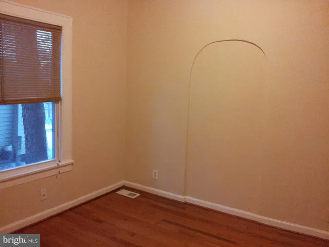 a room with a window and wooden floor