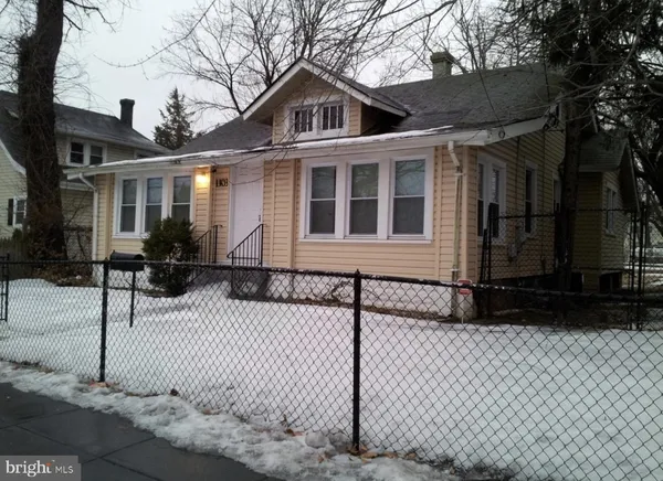 a view of a house with wooden fence