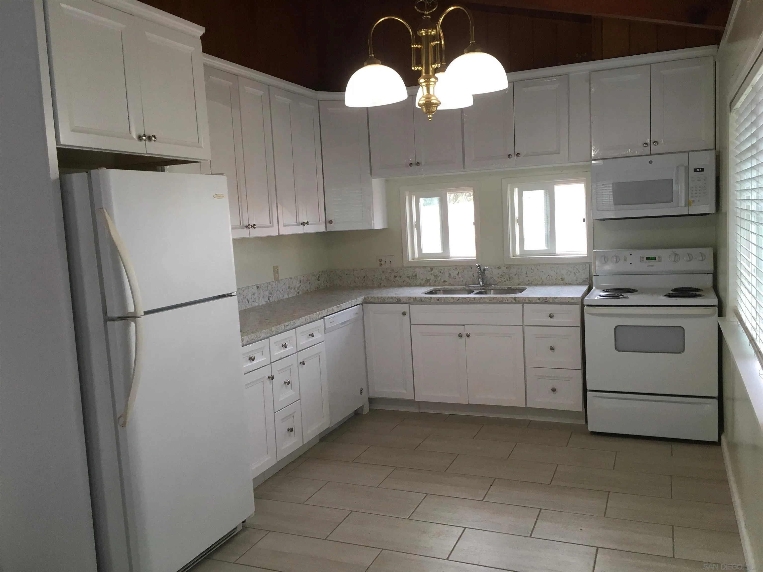 14631 Twin Peaks Road Poway, CA 92064 - Photo 4 of 12 a kitchen with cabinets appliances a sink and a window