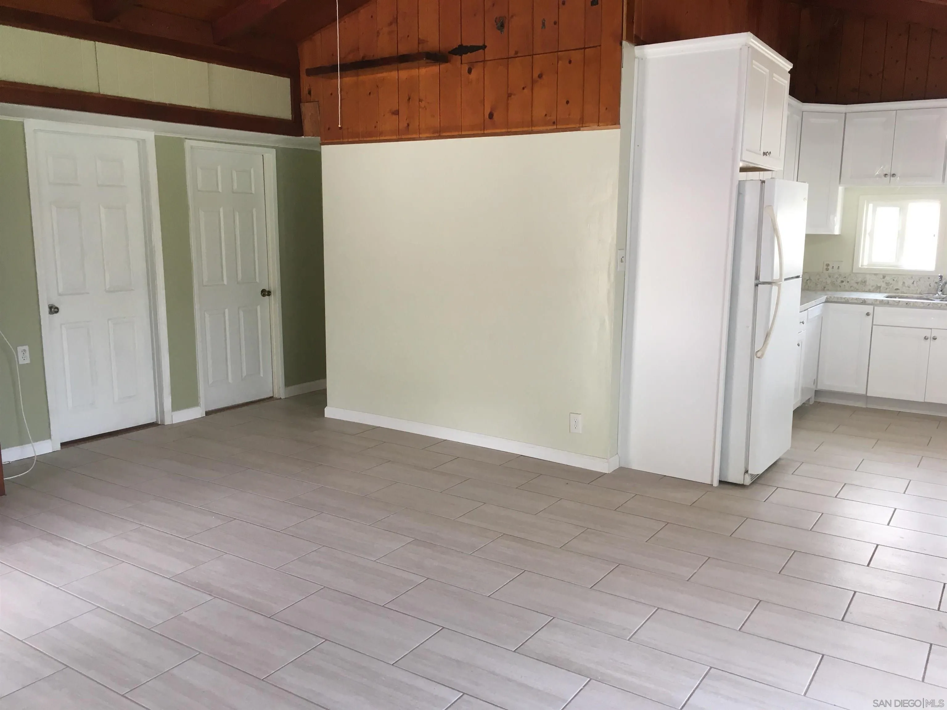 14631 Twin Peaks Road Poway, CA 92064 - Photo 5 of 12 a view of a refrigerator in kitchen and an empty room