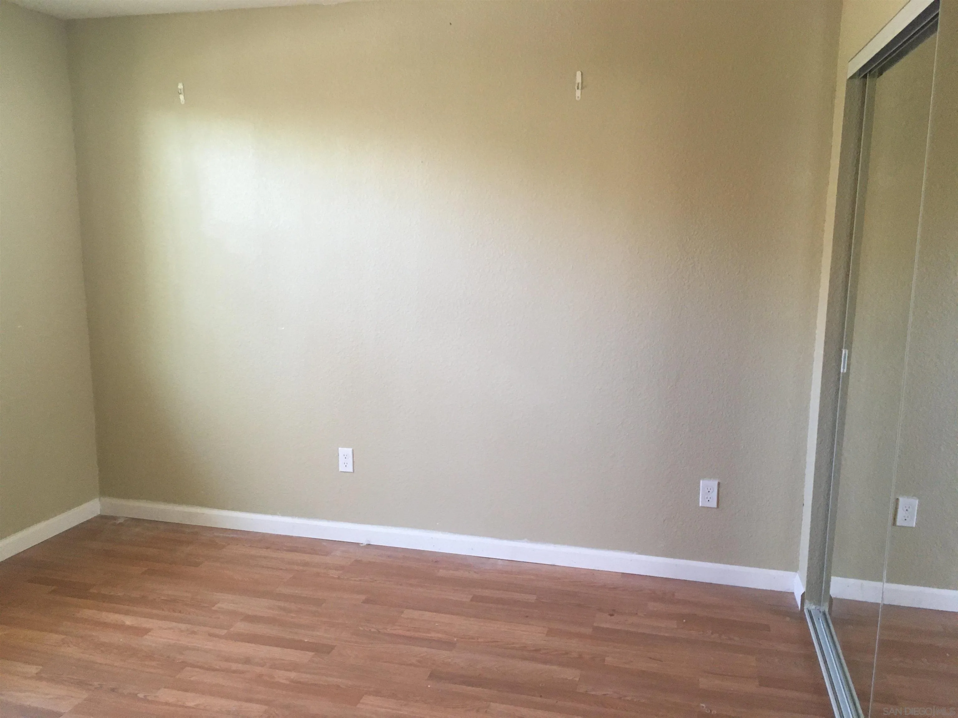 14631 Twin Peaks Road Poway, CA 92064 - Photo 7 of 12 a view of an empty room with wooden floor
