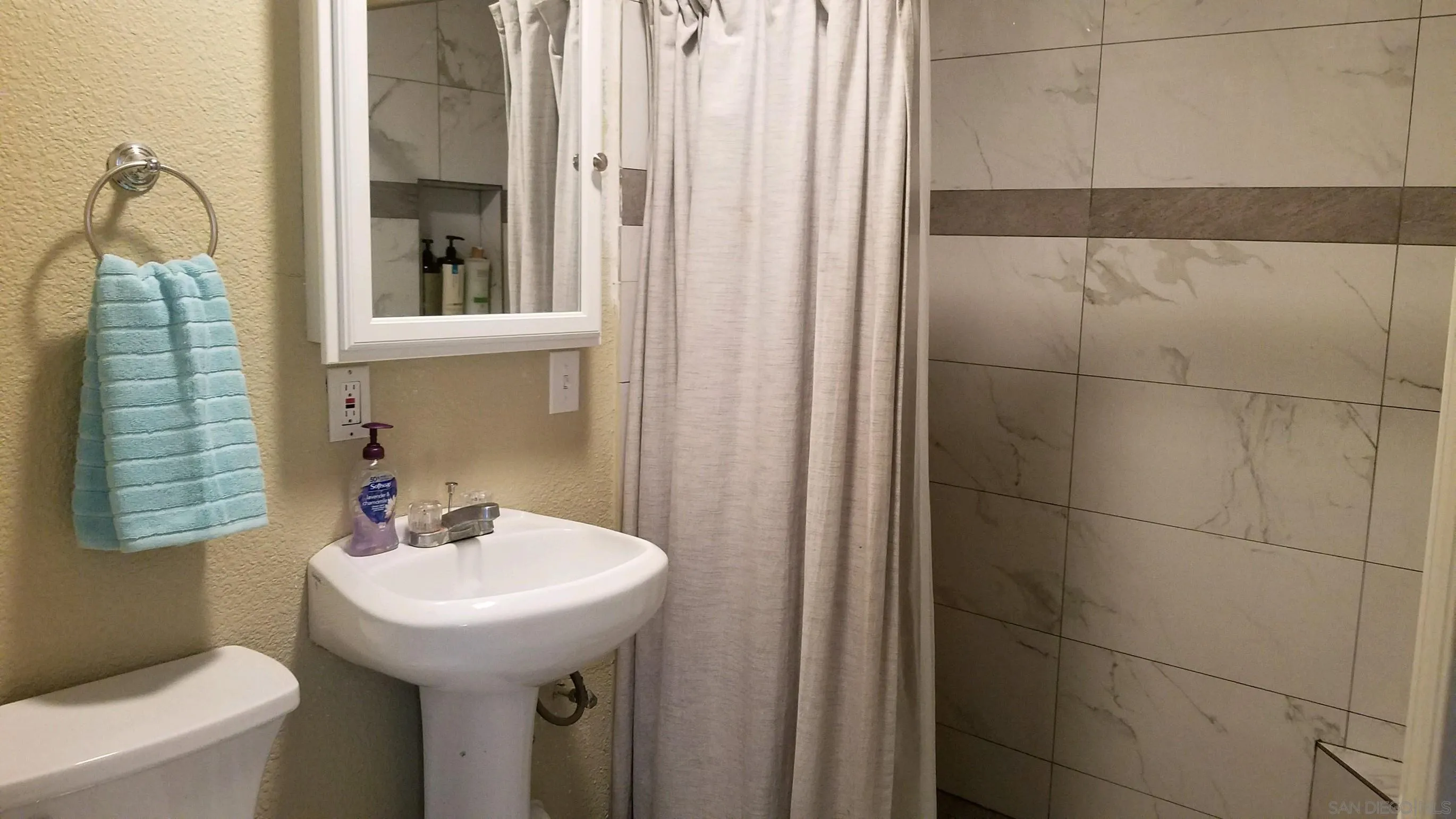 14631 Twin Peaks Road Poway, CA 92064 - Photo 8 of 12 a bathroom with a sink a toilet and shower