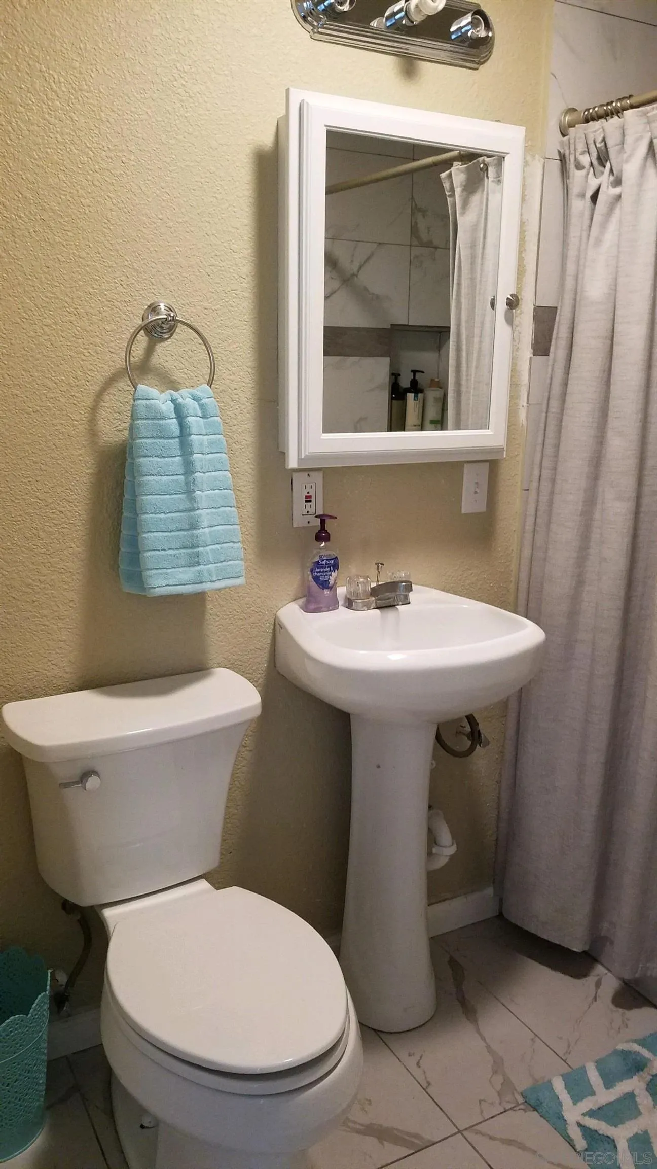 14631 Twin Peaks Road Poway, CA 92064 - Photo 9 of 12 a bathroom with a sink toilet and shower