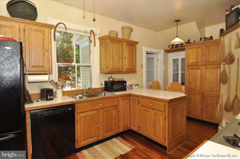1910 Grace Church Road Silver Spring, MD 20910 - Photo 1 of 16 a kitchen with a sink a refrigerator and cabinets