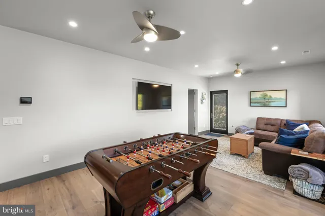 a view of a hallway with wooden floor and entryway