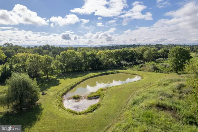 an aerial view of a house with big yard
