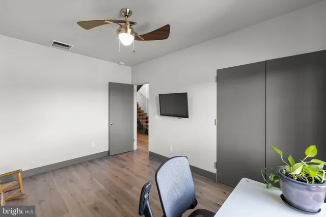 a dining room with stainless steel appliances a table and chairs