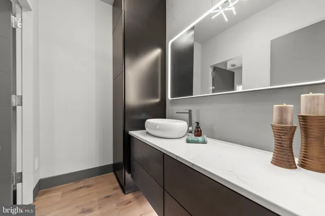 a view of a patio with couches table and chairs with wooden floor and fence