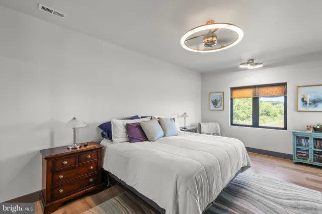 an aerial view of residential houses with outdoor space and lake view