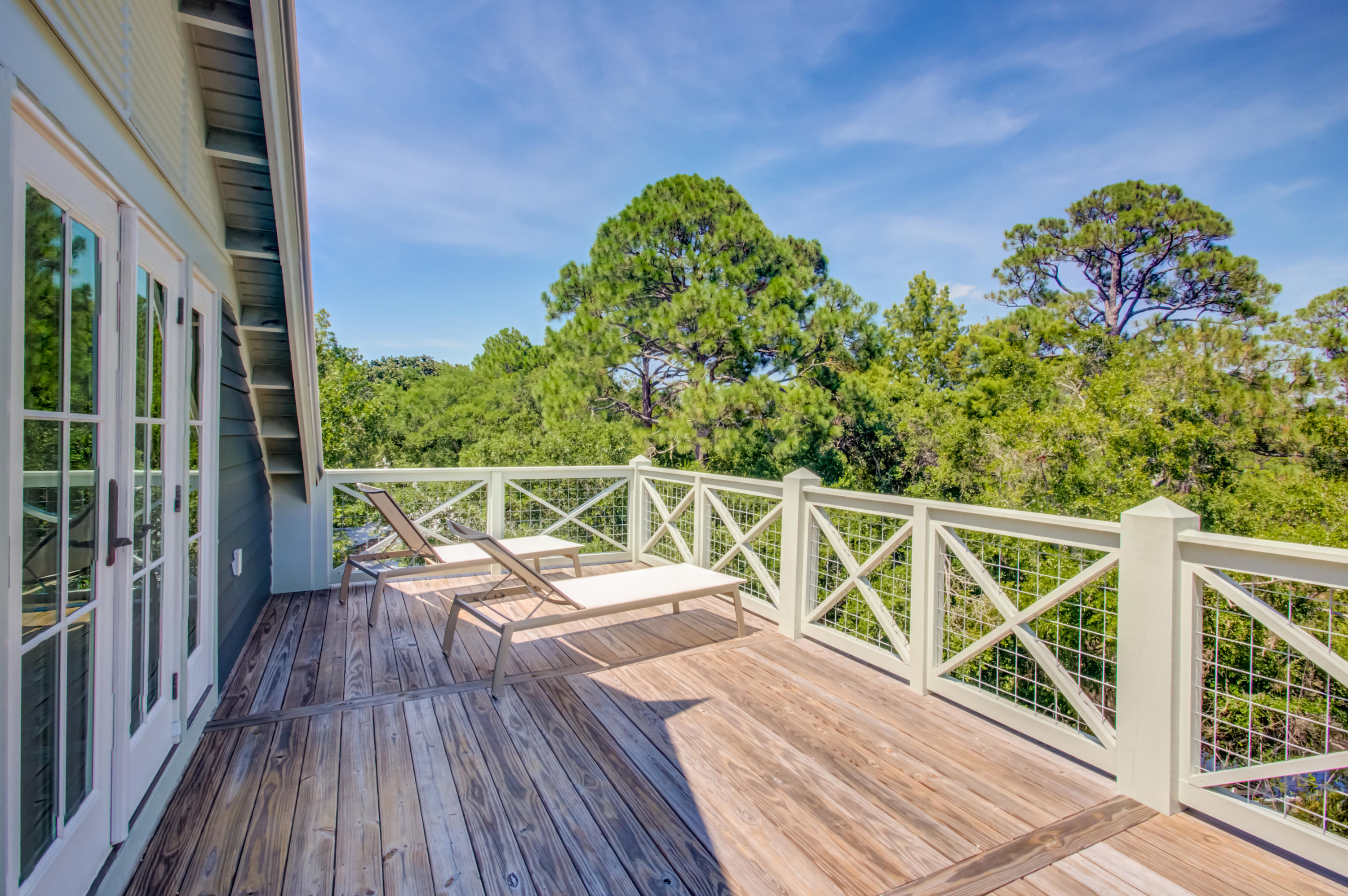 177 Grayton Trail Road Santa Rosa Beach, FL 32459 - Photo 35 of 78 a view of a balcony with two chairs and wooden floor