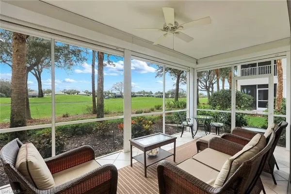 a living room with a large window and a table