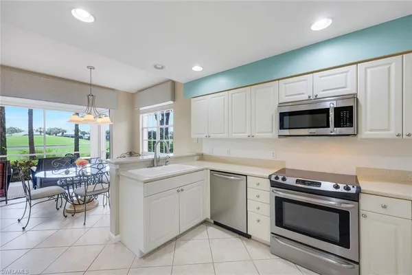 a kitchen with a sink stove and microwave