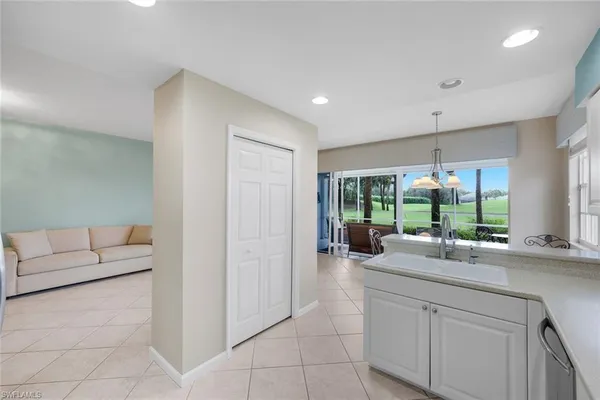 a kitchen with counter top space and living room