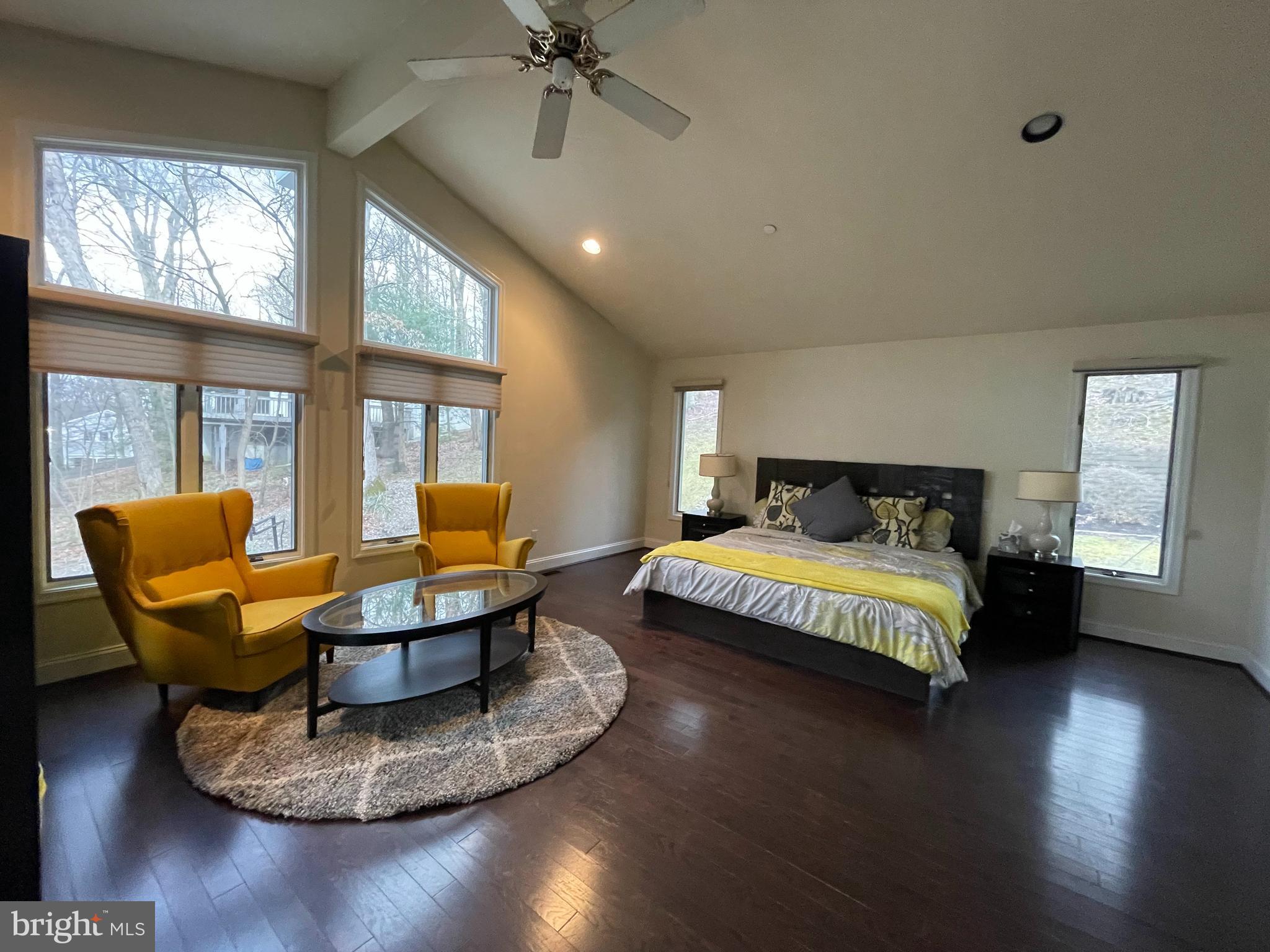 3300 Sawmill Road Newtown Square, PA 19073 - Photo 14 of 29 a spacious bedroom with a bed a couch and a large window
