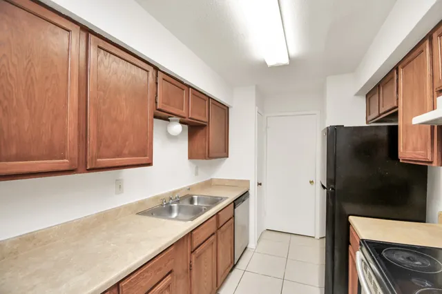 a kitchen with a refrigerator and a sink