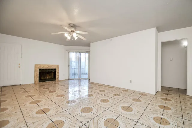 a view of a livingroom with a ceiling fan and window