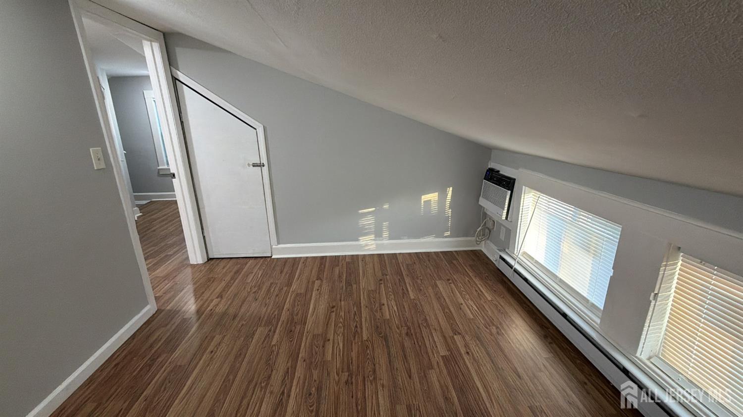 463 Valmere Avenue Piscataway, NJ 08854 - Photo 13 of 18 a view of an empty room with wooden floor and a window