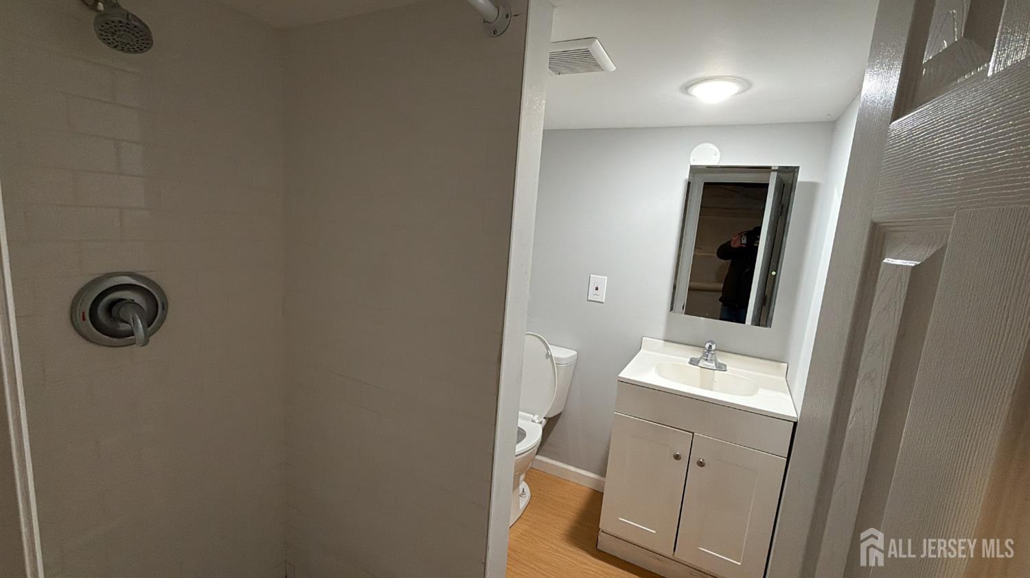 463 Valmere Avenue Piscataway, NJ 08854 - Photo 16 of 18 a bathroom with a sink a toilet and mirror
