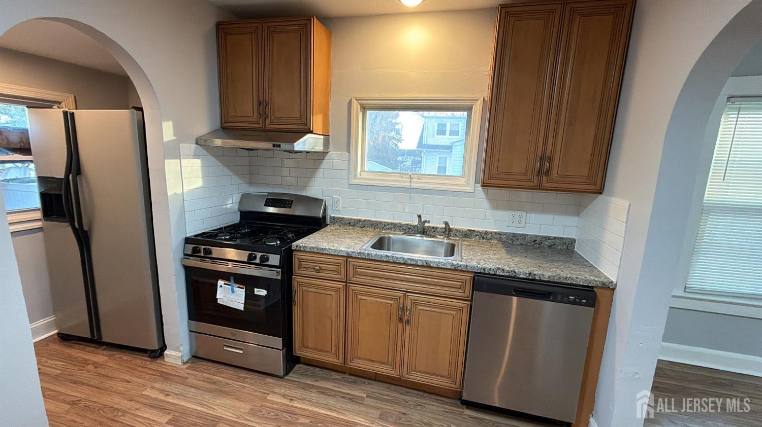 463 Valmere Avenue Piscataway, NJ 08854 - Photo 7 of 18 a kitchen with granite countertop a sink stove and refrigerator