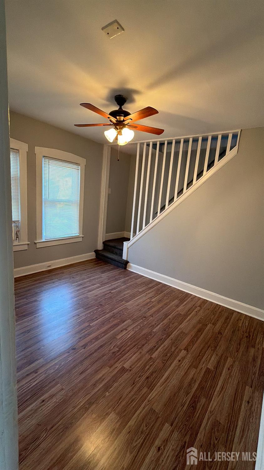 463 Valmere Avenue Piscataway, NJ 08854 - Photo 9 of 18 a view of an empty room with wooden floor and a ceiling fan