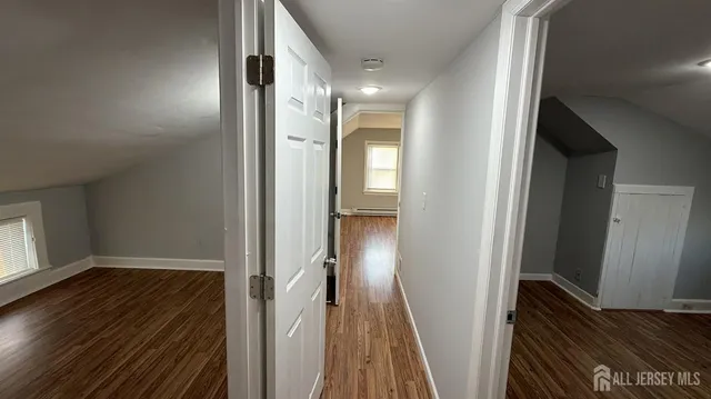 a view of hallway with wooden floor