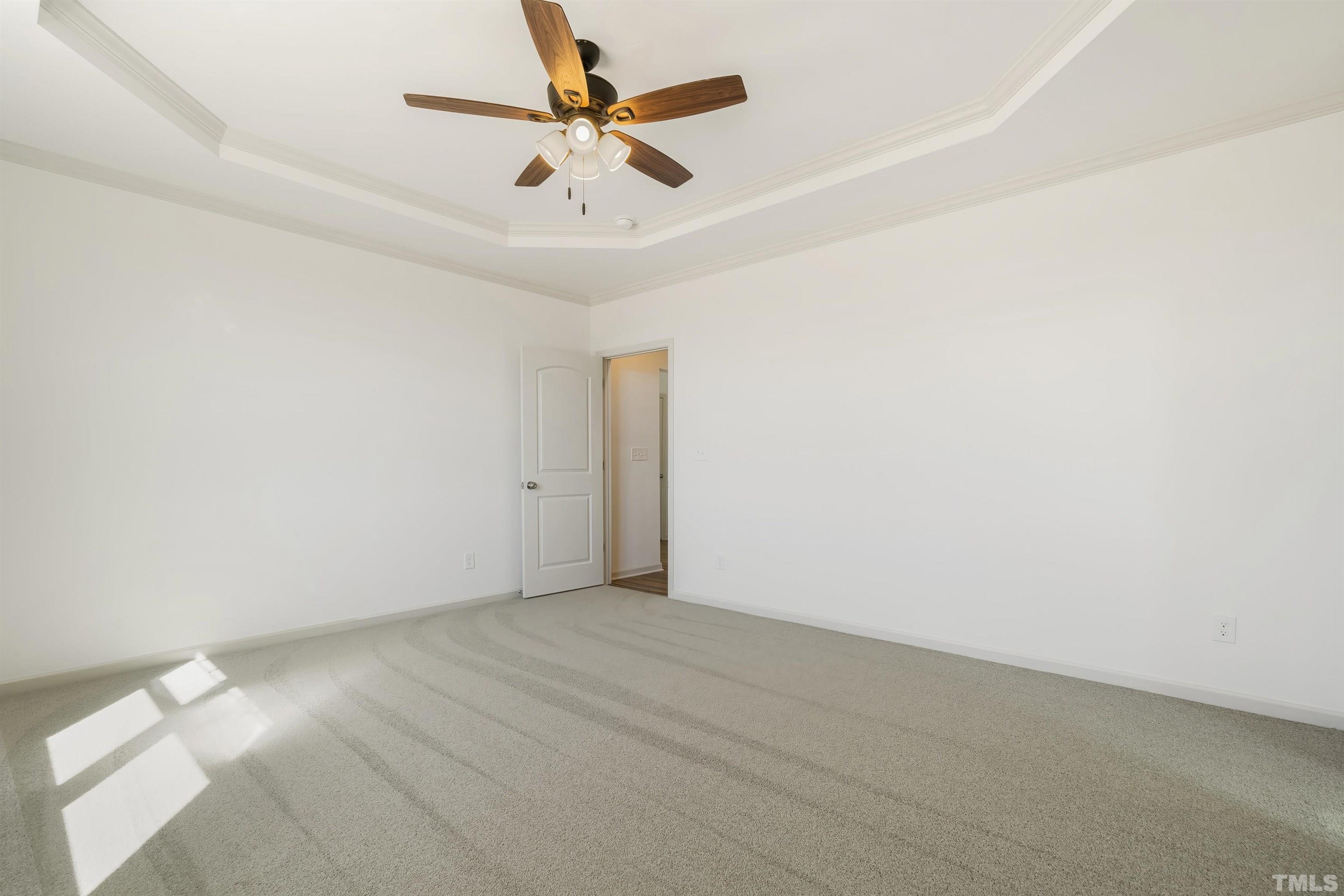 4107 Needham Road Bailey, NC 27807 - Photo 11 of 24 an empty room with a chandelier fan and windows