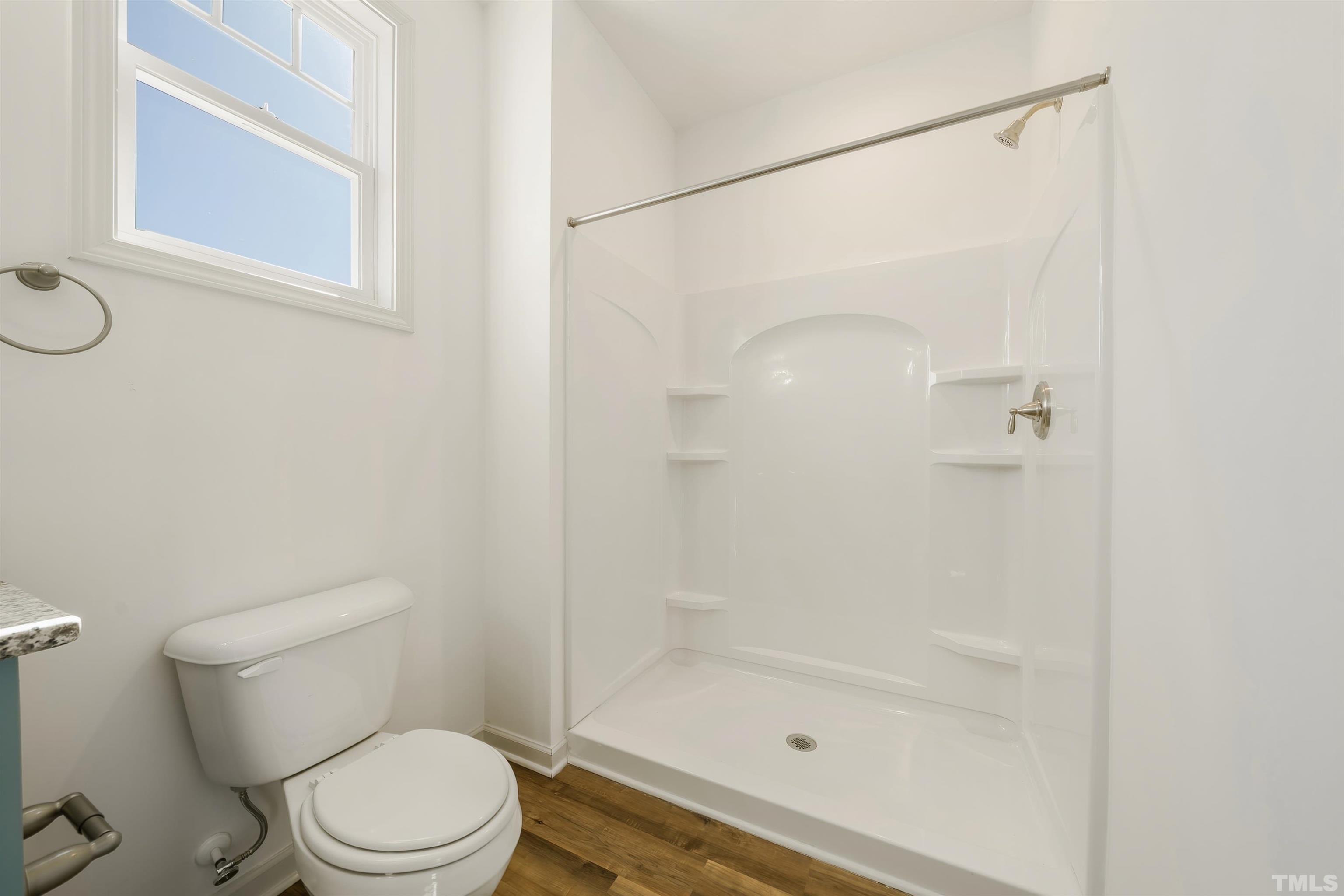 4107 Needham Road Bailey, NC 27807 - Photo 14 of 24 a white toilet sitting next to a bath tub shower