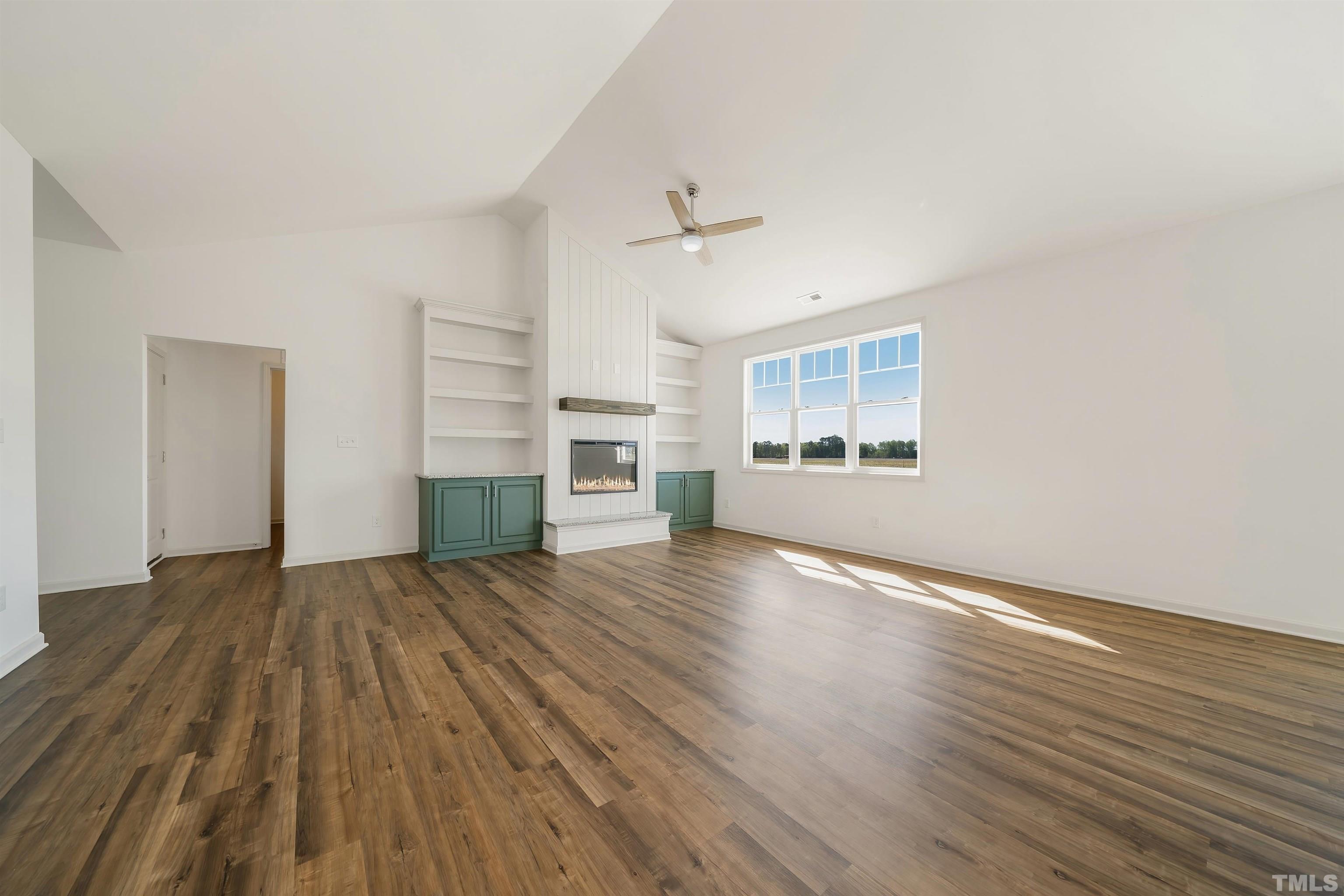 4107 Needham Road Bailey, NC 27807 - Photo 3 of 24 an empty room with wooden floor kitchen view and a window