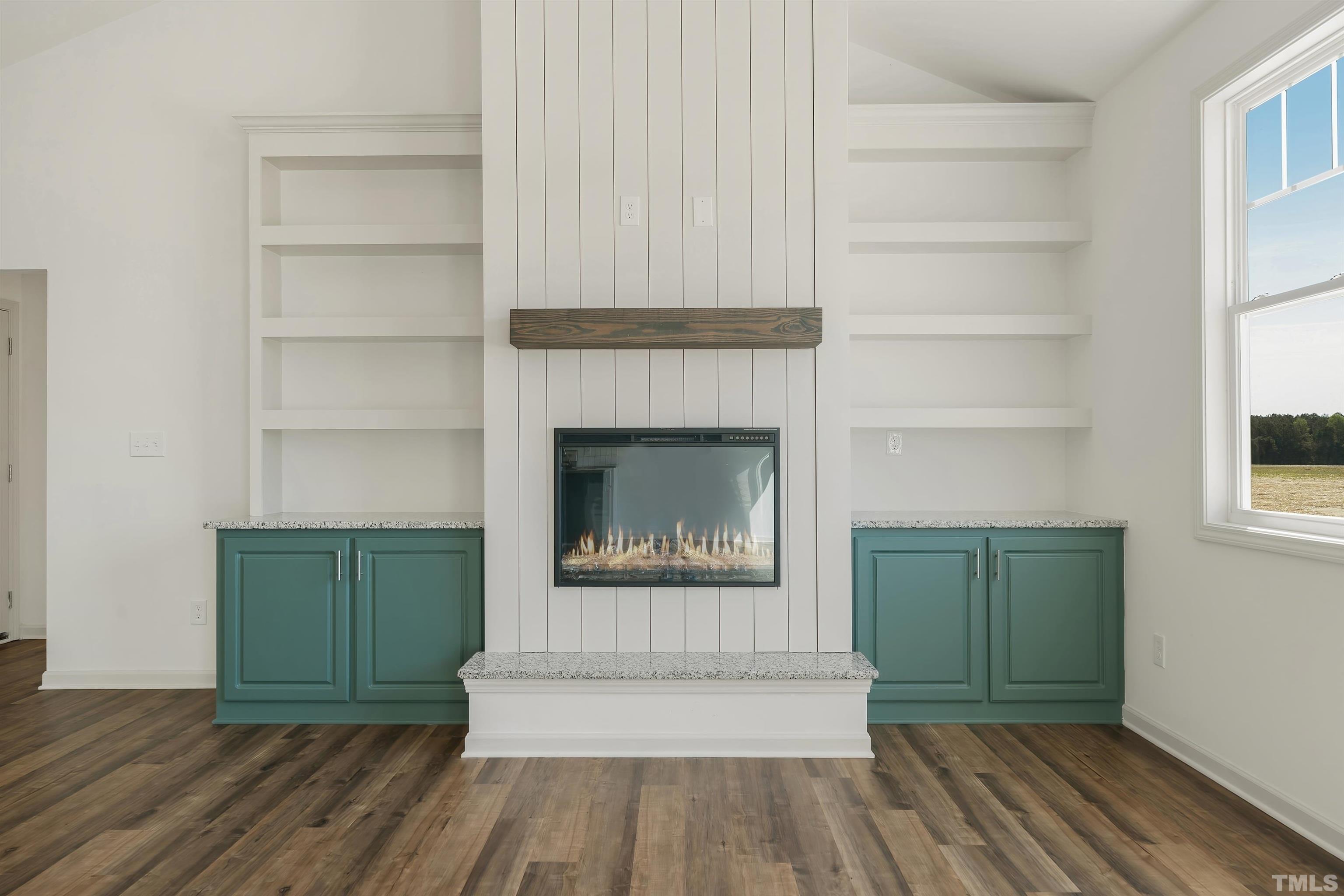 4107 Needham Road Bailey, NC 27807 - Photo 4 of 24 a living room with a fireplace and a window
