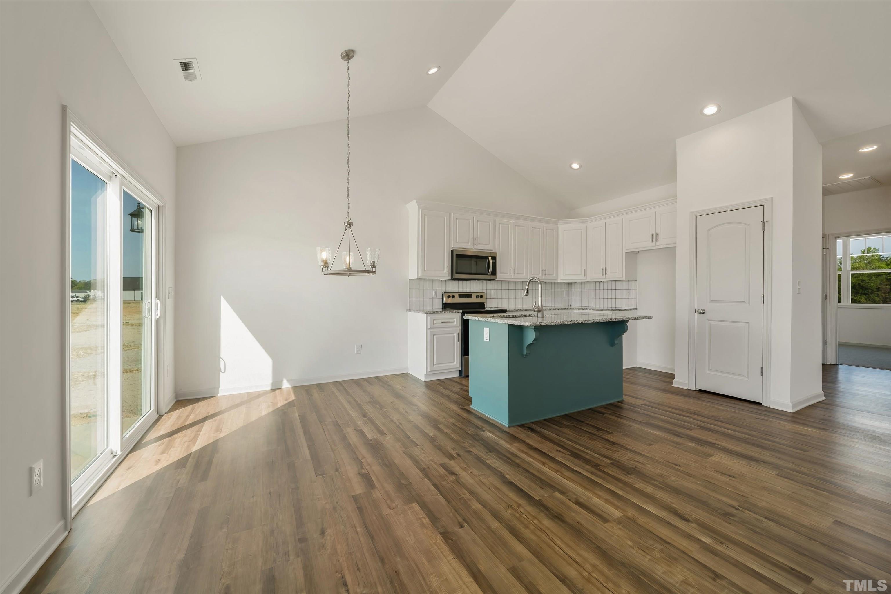4107 Needham Road Bailey, NC 27807 - Photo 8 of 24 a kitchen with stainless steel appliances kitchen island wooden cabinets and granite counter tops