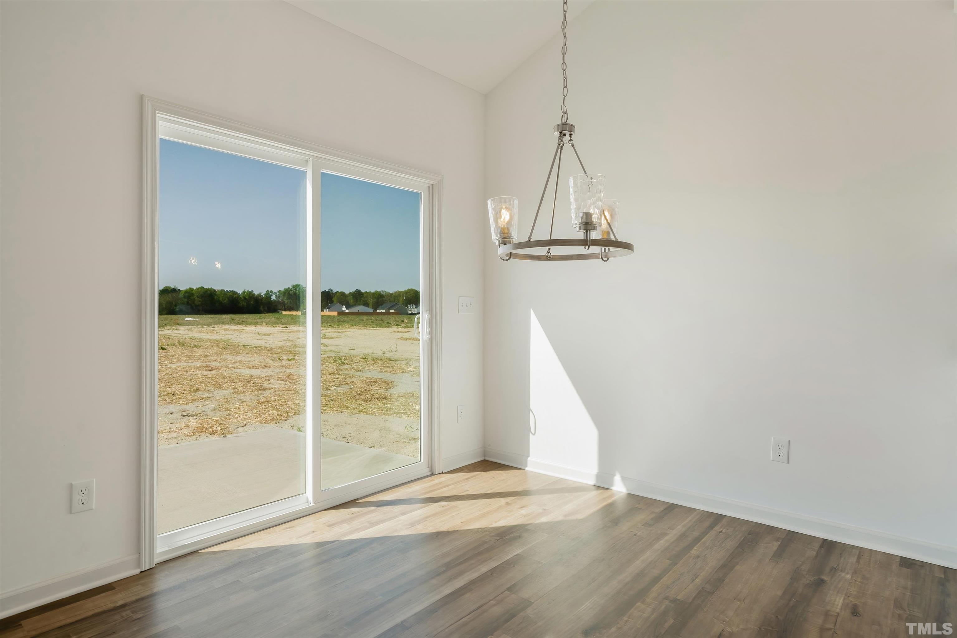 4107 Needham Road Bailey, NC 27807 - Photo 9 of 24 an empty room with wooden floor and windows