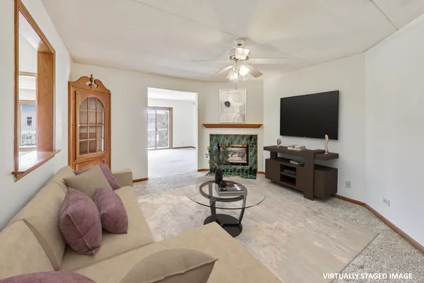 a living room with furniture a fireplace and a flat screen tv