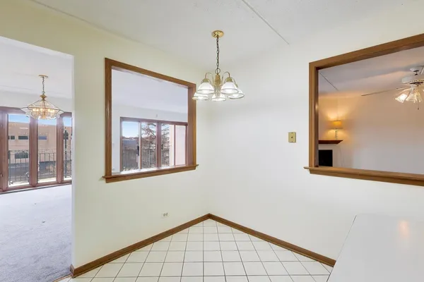 a view of a hallway with entryway and chandelier