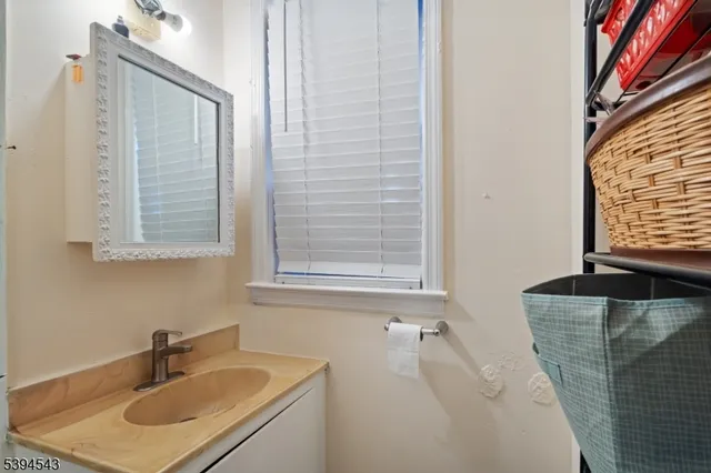 a bathroom with a sink vanity granite tub and a mirror