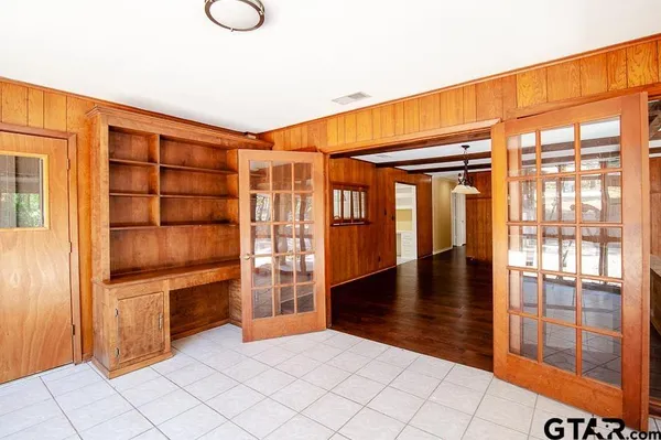 a view of empty room with wooden floor and floor to ceiling window
