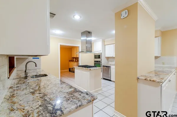 a kitchen with a sink stove and cabinets