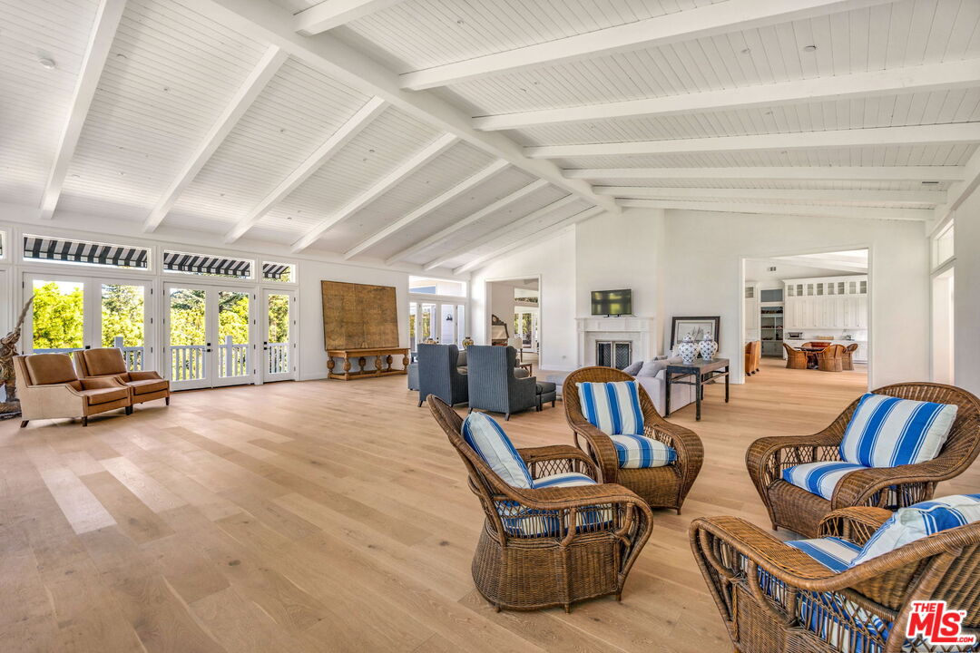 9669 Oak Pass Road Beverly Hills, CA 90210 - Photo 17 of 37 a living room with furniture and a wooden floor