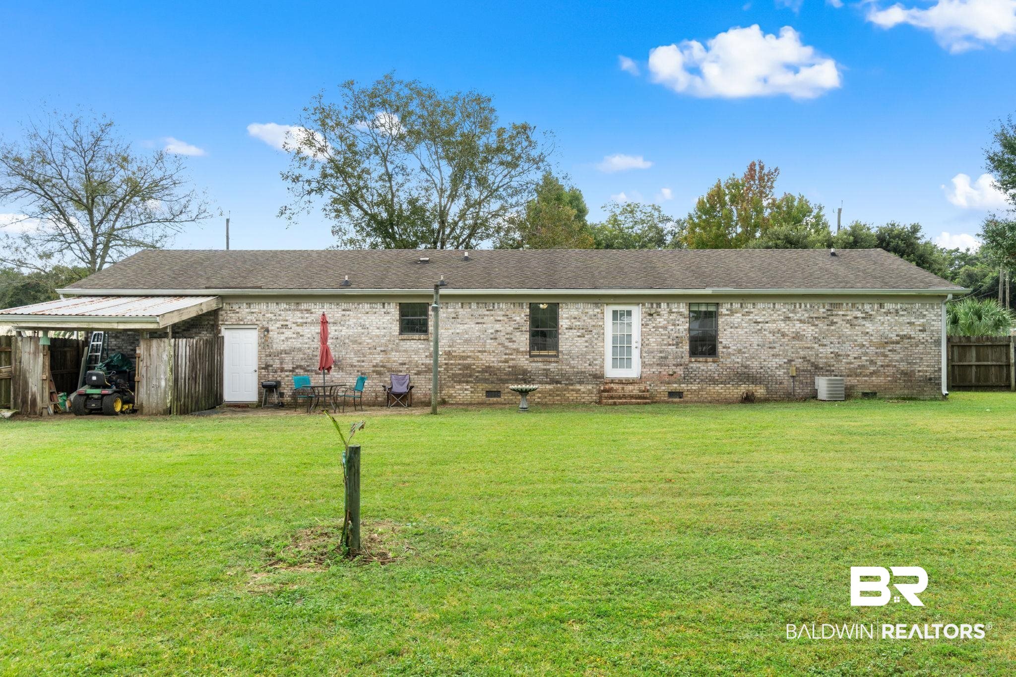 33135 Collier Road Lillian, AL 36549 - Photo 25 of 30 Rear view of house featuring crawl space and brick siding