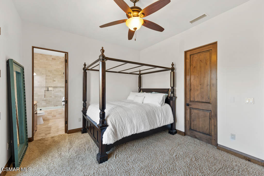 8577 Happy Camp Road Moorpark, CA 93021 - Photo 33 of 96 a bedroom with a bed and a chandelier
