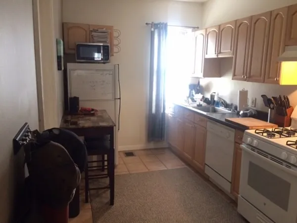 a kitchen with a refrigerator and a stove top oven