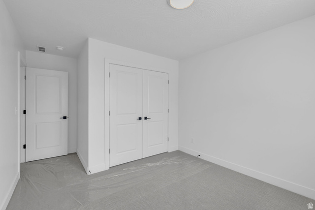 2821 Scarlet Road, Unit 149 Eagle Mountain, UT 84005 - Photo 15 of 28 Bright bedroom featuring closet with double doors.