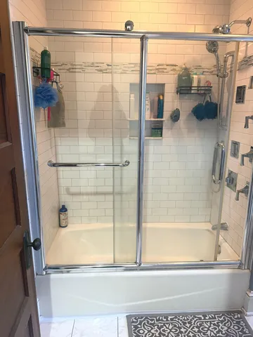 a bathroom with a bathtub and a shower