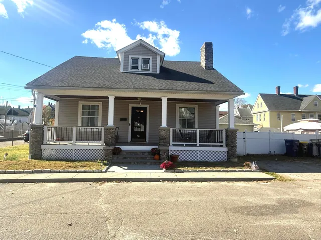 a view of a house with swimming pool and sitting area