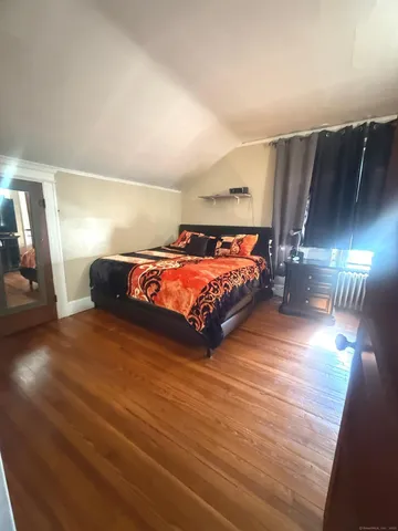 a bedroom with a bed and lamp