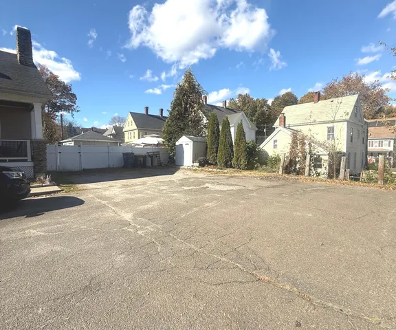 a front view of a house with a yard table and chairs