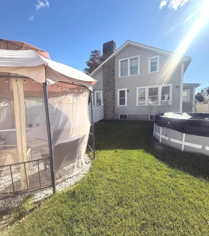 a view of a room with water heater and wooden floor