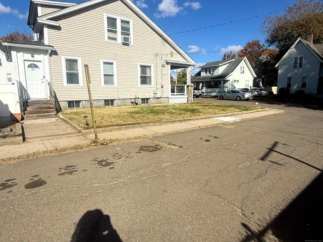 a view of a house with snow on the road