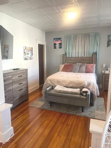 a bedroom with a bed and a dresser