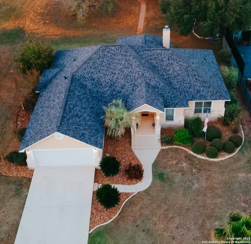 an aerial view of a house with a yard