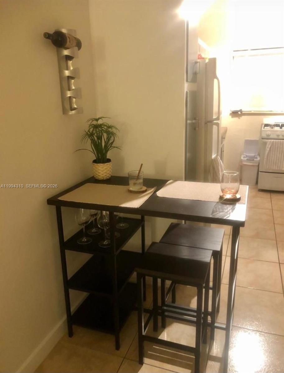 620 76th Street, Unit 11 Miami Beach, FL 33141 - Photo 11 of 14 a dining room with furniture and wooden floor